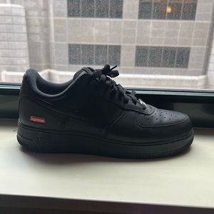 Black Nike Supreme Air Force Ones.
